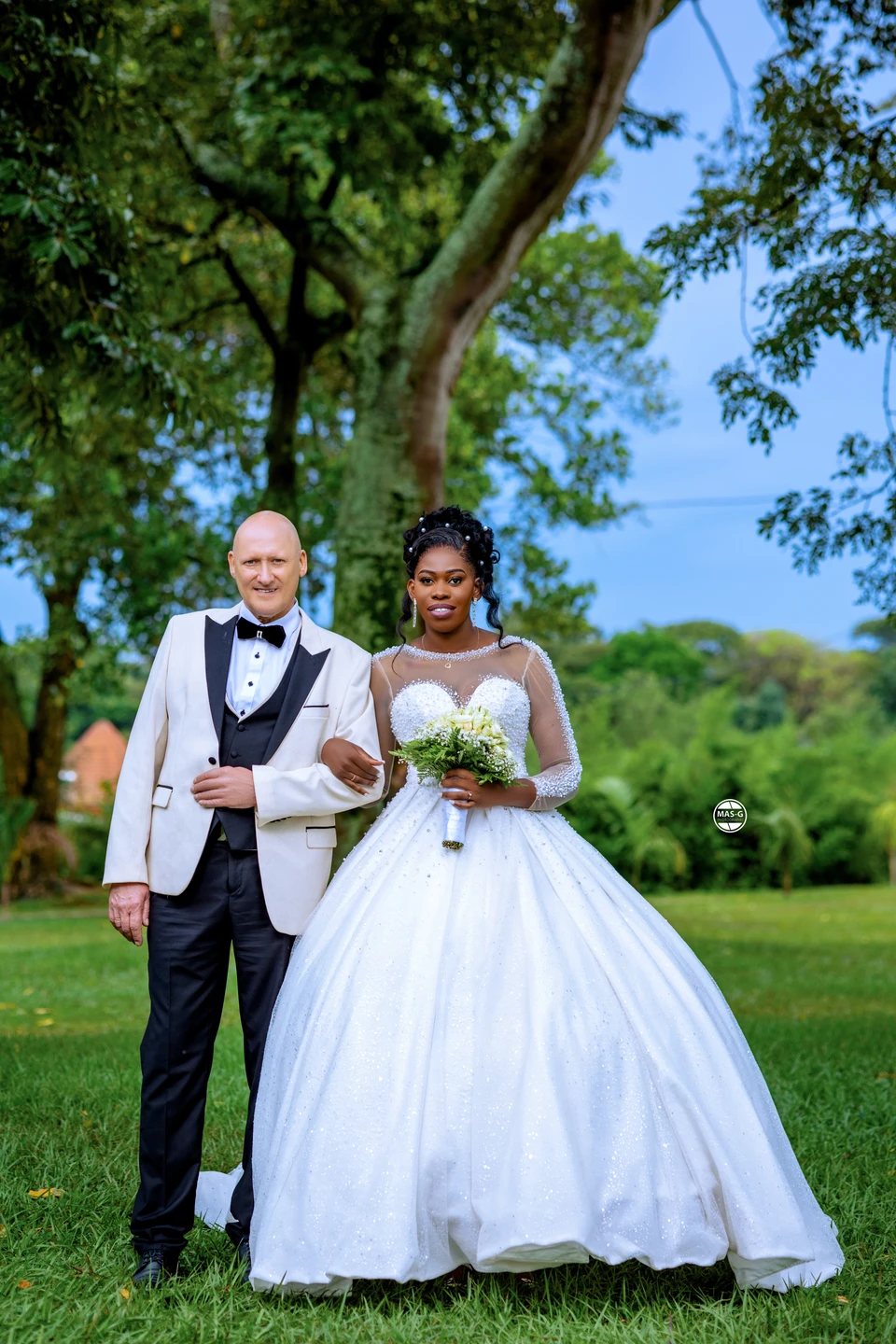 Full-length garden portrait of a bride and groom
